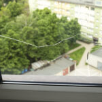 Crack, Broken Glass In A Double-glazed Window Due To Temperature Difference In Building, Home. Horizontal Plane. Closeup